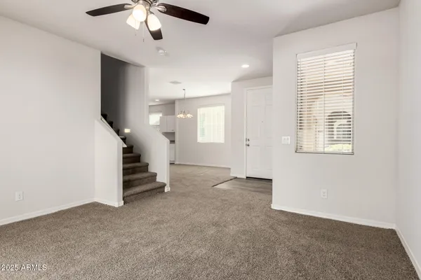 en view interior of a house with stairs and a ceiling fan