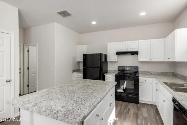 a kitchen with a stove and a refrigerator