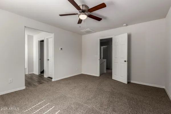 a view of empty room with ceiling fan