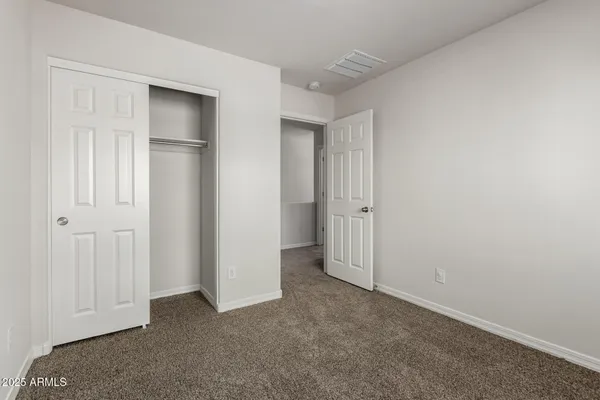 an empty room with closet area