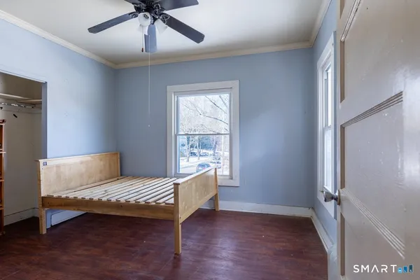 a living room with a bed furniture and a window