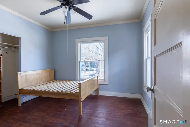 a living room with a bed furniture and a window