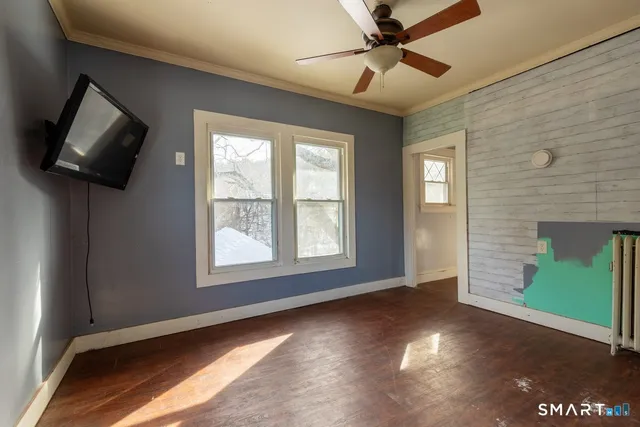 a view of livingroom with window ceiling fan and hardwood floor