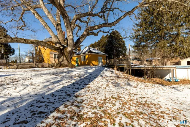 a view of a backyard with snow on the road