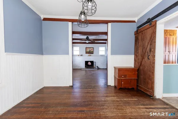 a view of a livingroom with furniture window and wooden floor