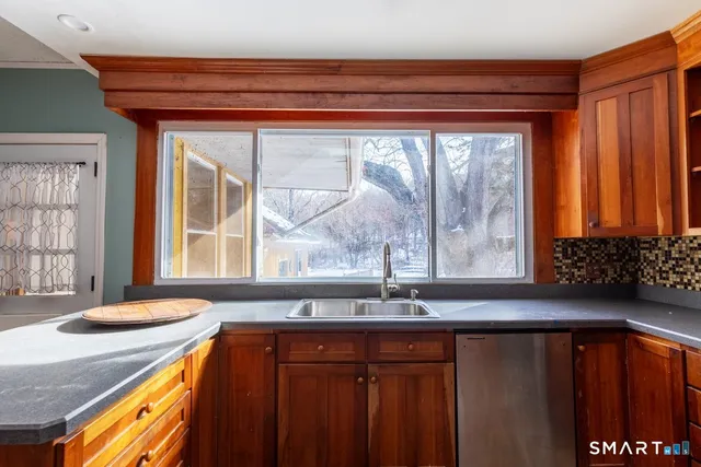 a kitchen with stainless steel appliances granite countertop a sink and a cabinets