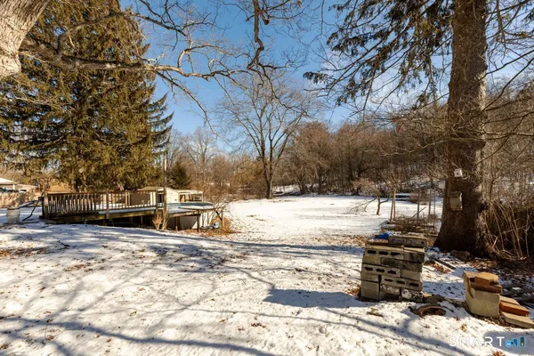 a view of yard covered with snow in front of house