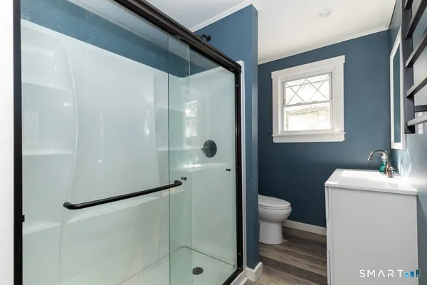 a bathroom with a sink toilet and shower