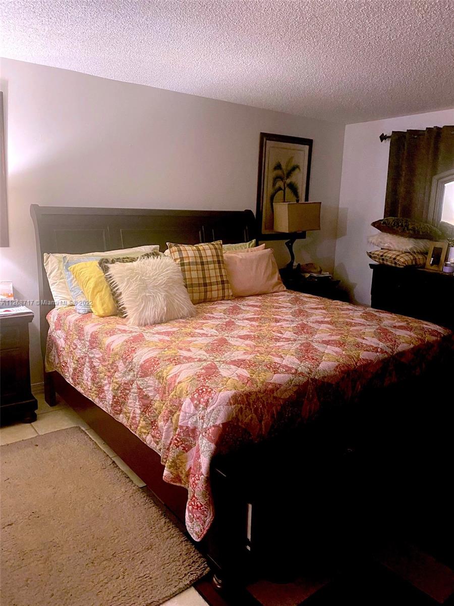 Inverrary Lauderhill, FL 33319 - Photo 6 of 9 a bedroom with a bed and dresser