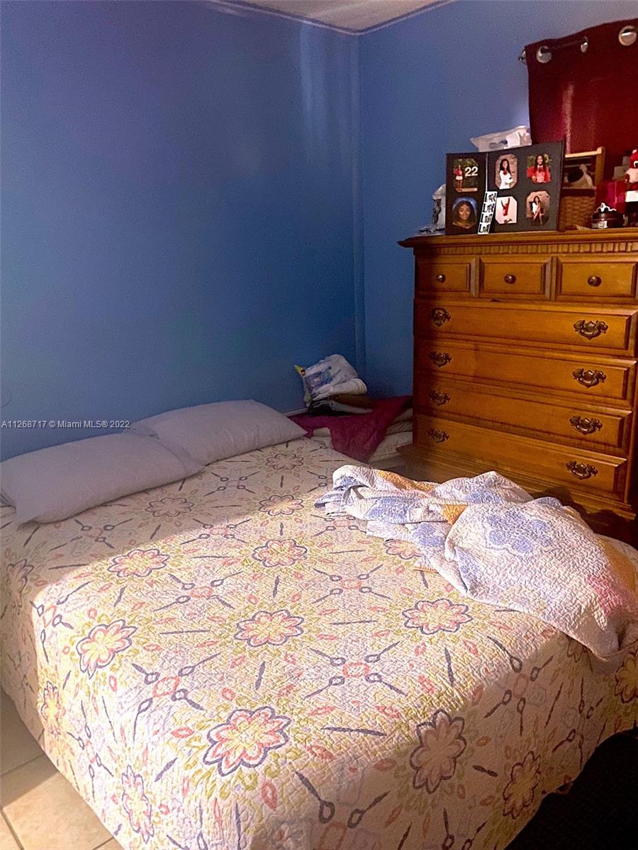 Inverrary Lauderhill, FL 33319 - Photo 8 of 9 a bed sitting in a bedroom and dresser with wooden floor