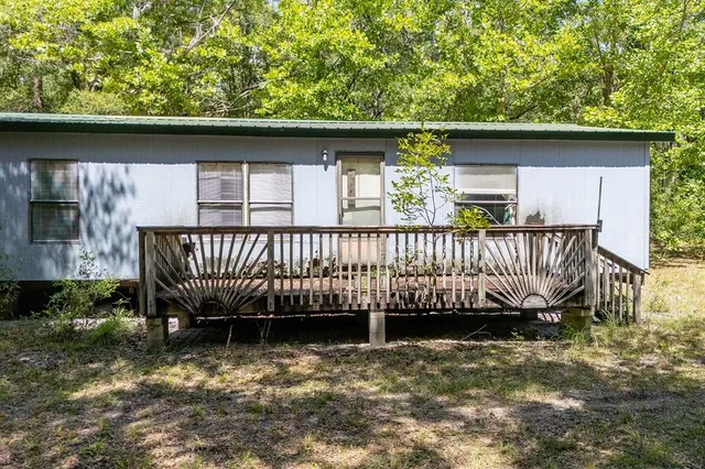 a side of a small house with a canopy over it