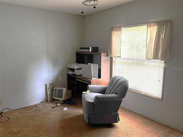 a work room with furniture and a window