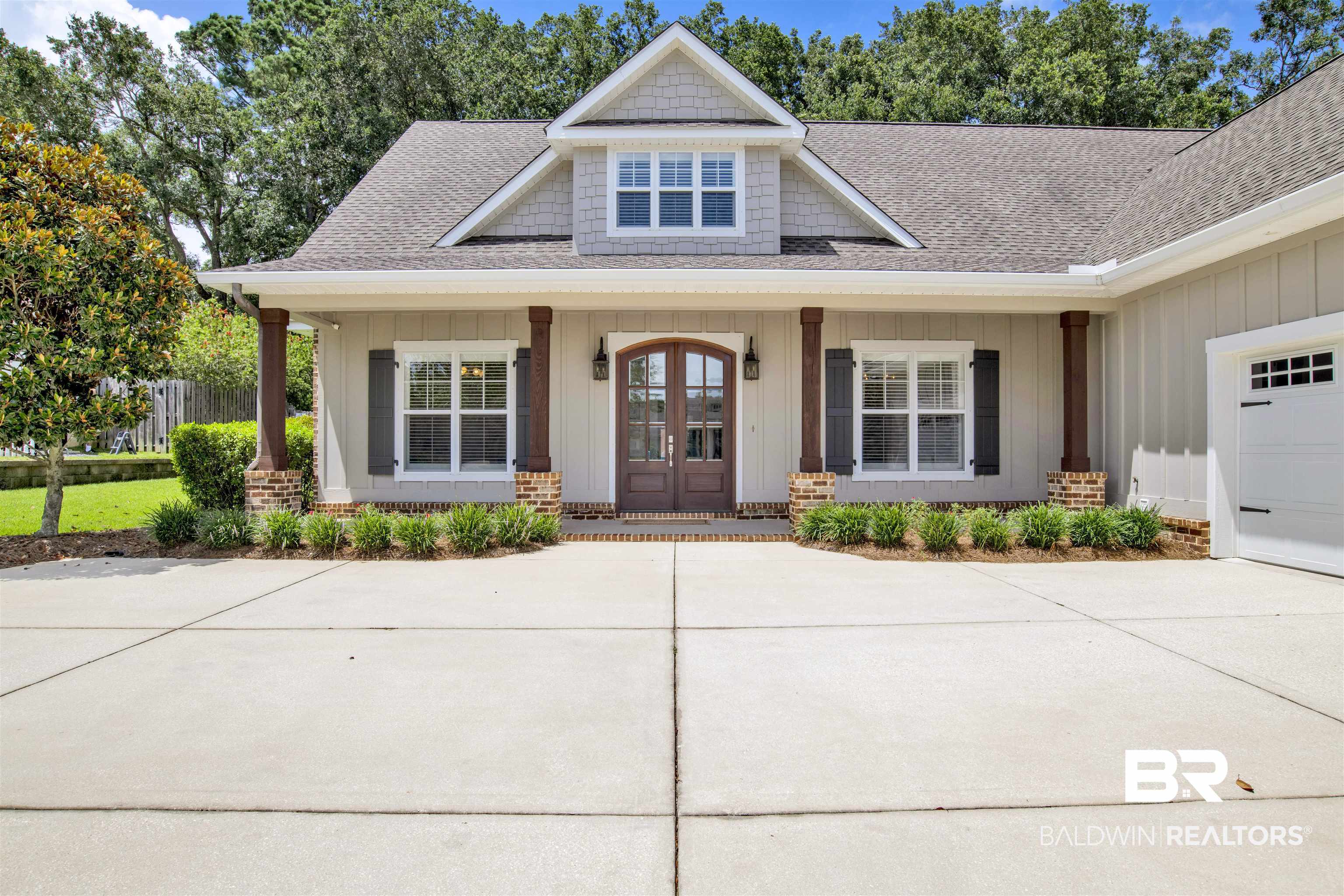 131 Sedgefield Avenue Fairhope, AL 36532 - Photo 4 of 50 View of front of property featuring covered porch and a garage