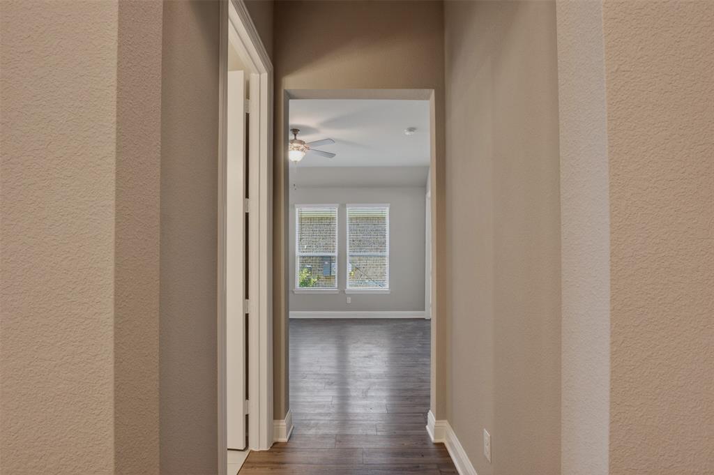 16812 Bitterroot Road Justin, TX 76247 - Photo 4 of 27 a view of a hallway with wooden floor