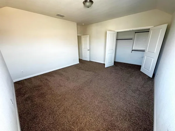 a spacious bathroom with a double vanity sink and a mirror