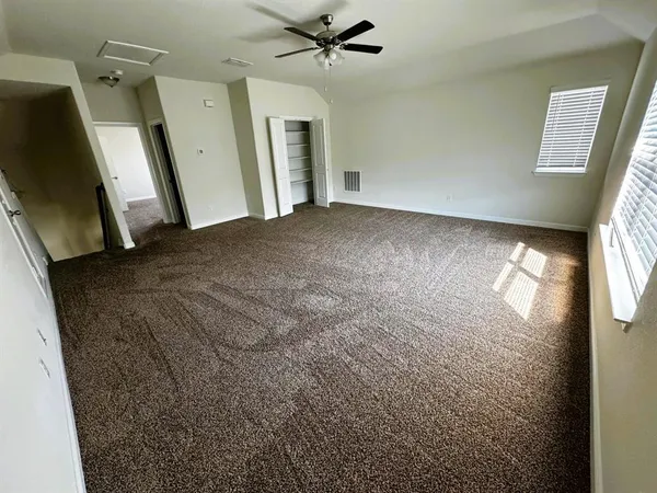 a view of a livingroom with an empty space and a window