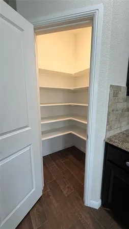 a room with a hardwood floor and a window