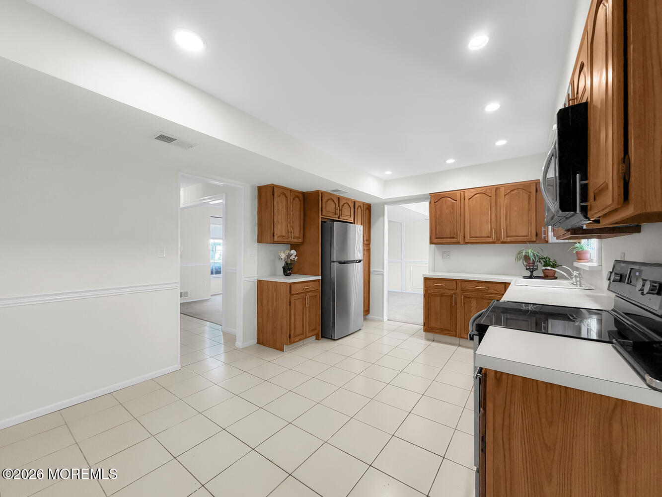 7 Meadow Court Hazlet, NJ 07730 - Photo 27 of 68 a kitchen with stainless steel appliances a stove sink microwave and cabinets