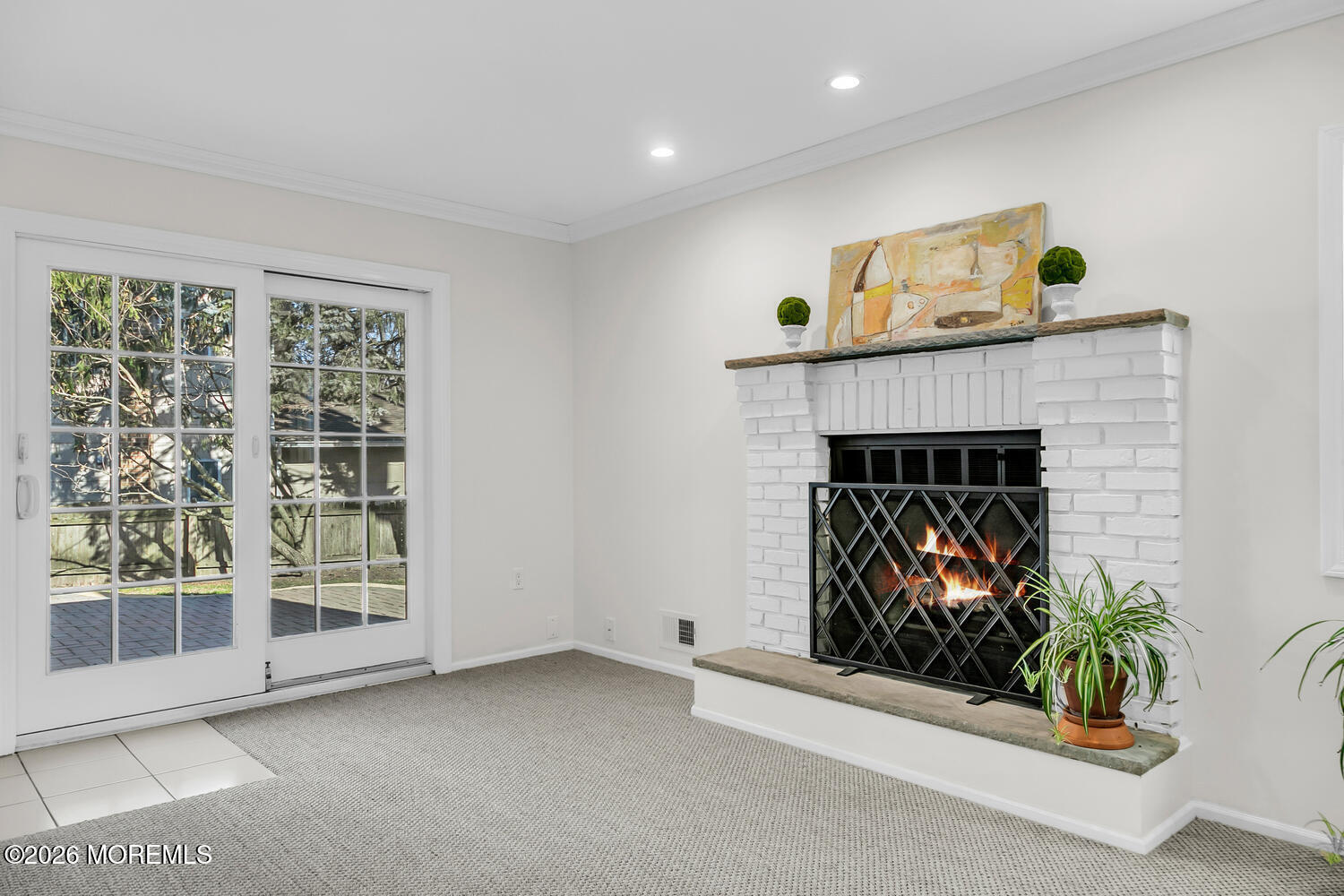 7 Meadow Court Hazlet, NJ 07730 - Photo 29 of 68 a living room with a fireplace and a potted plant