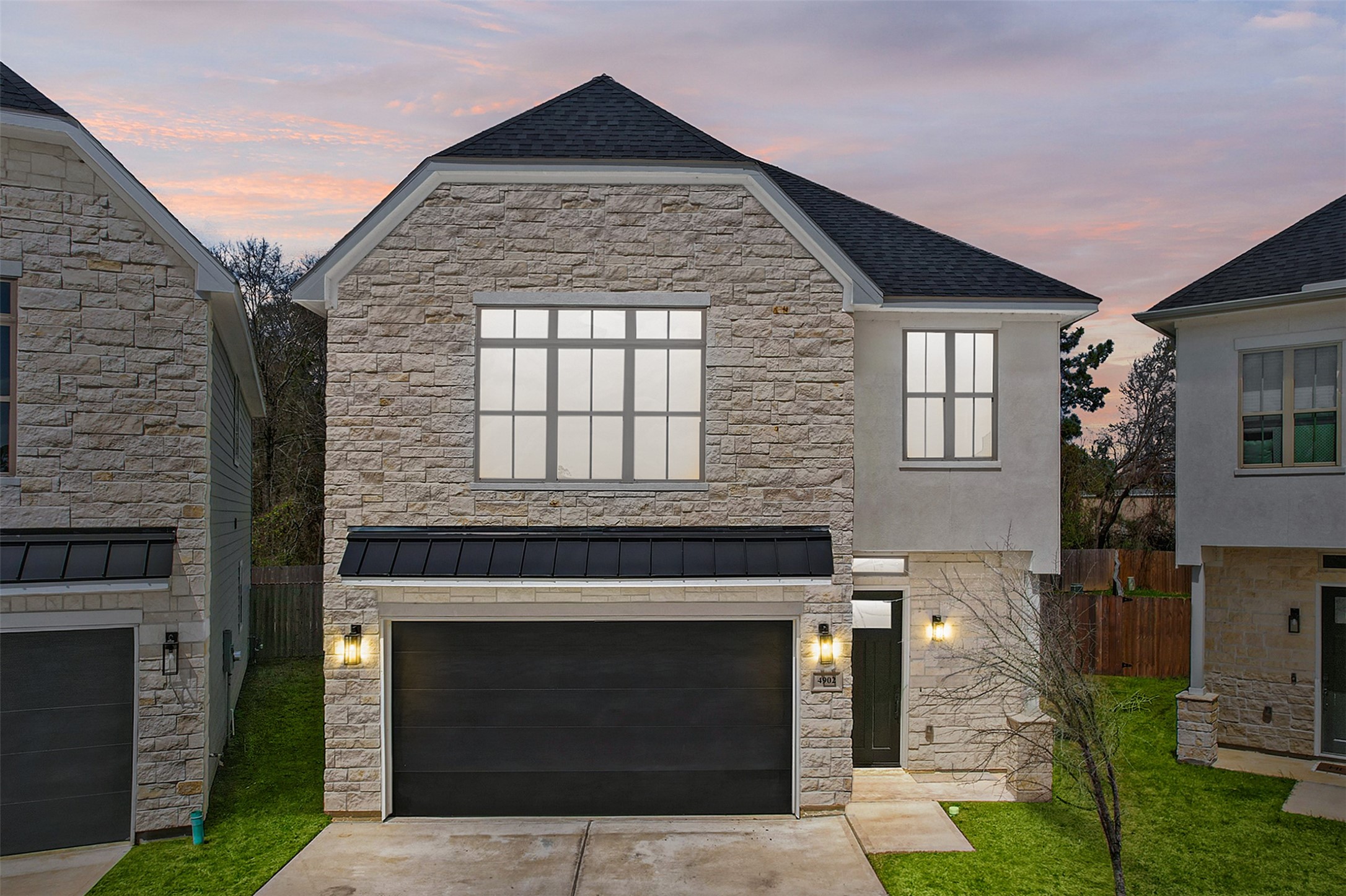 With a stone facade, contrasting light and dark features, and well-maintained lawn, the modern features add a touch of luxury to your new home.