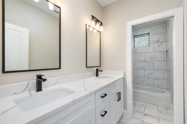 a bathroom with double vanity sinks double vanity tub and a mirror