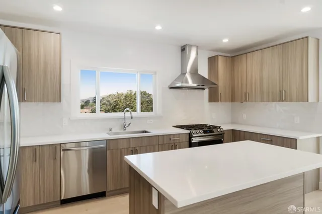 a kitchen with stainless steel appliances a sink and a stove