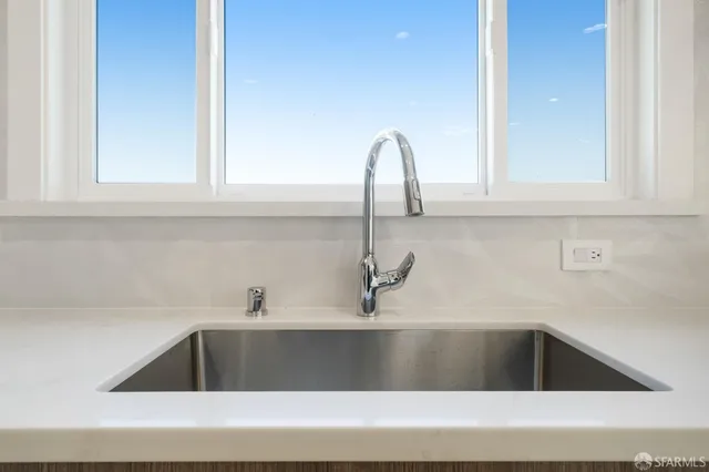 a kitchen with a sink and cabinets