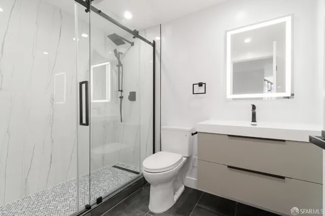 a bathroom with a sink toilet and shower