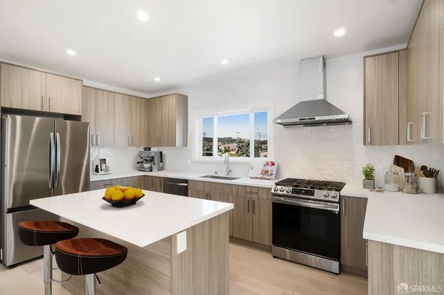 a kitchen with a stove a sink and a refrigerator