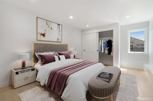 a bed room with a bed and a painting on the wall