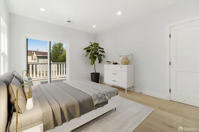 a bedroom with a bed and a potted plant