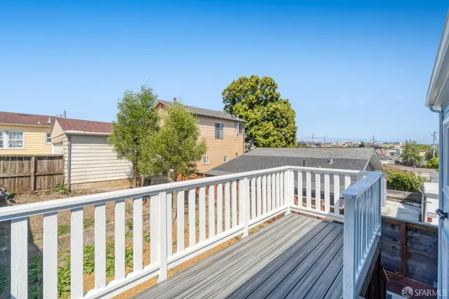 a view of a balcony with wooden floor