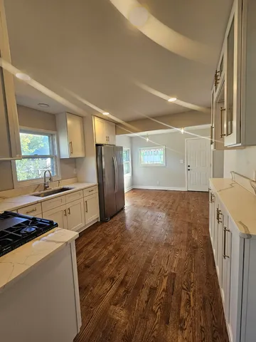 a kitchen with refrigerator and window