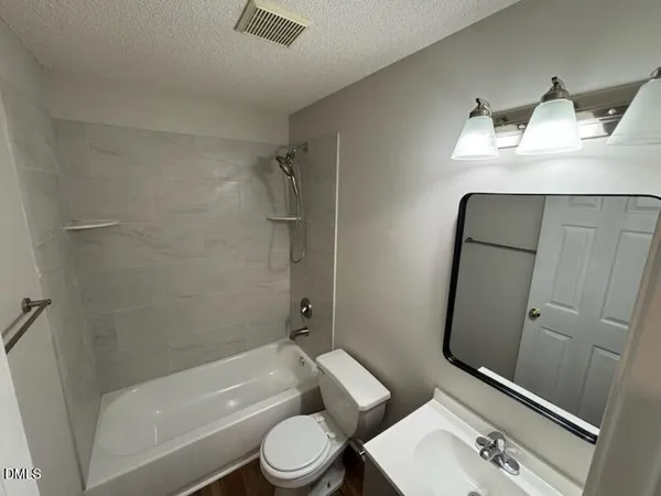 a bathroom with a toilet a sink and bathtub