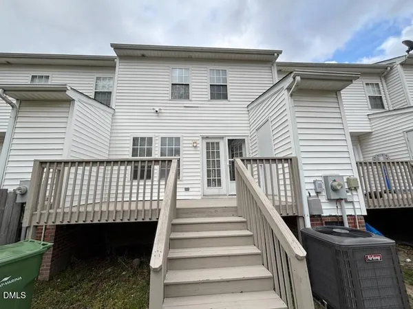 a view of a patio with table and chairs with wooden floor and fence