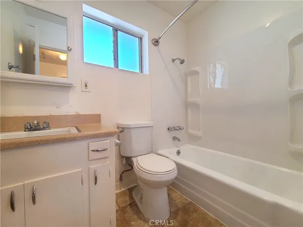 a bathroom with a sink a toilet and a bathtub