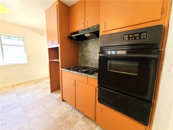 a kitchen with a stove and a cabinet
