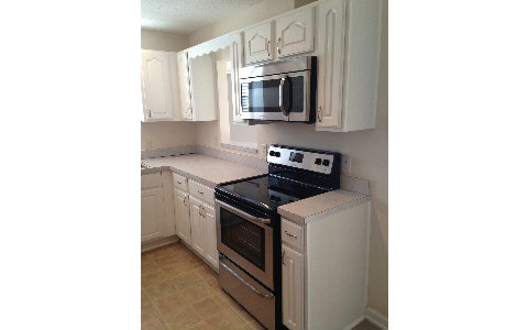 44206 Quail Ridge Avenue East Callahan, FL 32011 - Photo 3 of 15 a kitchen with stainless steel appliances a stove and microwave