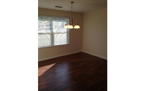 44206 Quail Ridge Avenue East Callahan, FL 32011 - Photo 4 of 15 a picture of a room with a window and wooden floor
