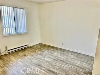 a view of a room with wooden floor and cabinet