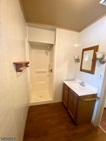 a bathroom with a sink mirror and shower