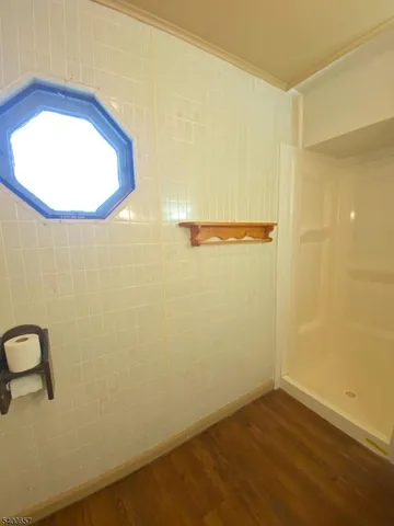 a view of a room with wooden floor and a sink