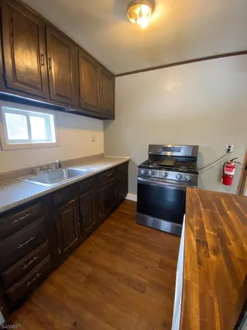 a kitchen with granite countertop cabinets and steel stainless steel appliances