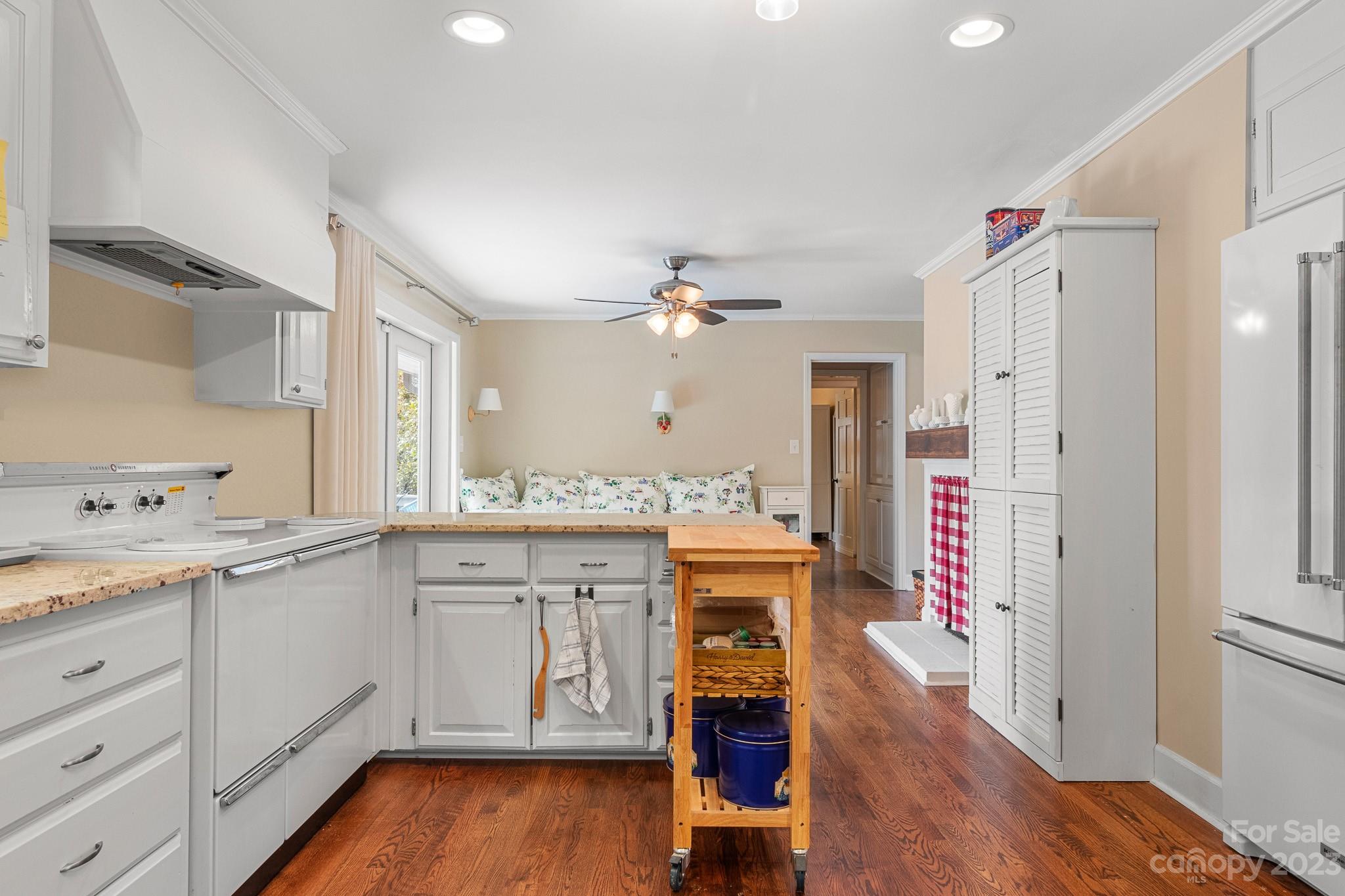 209 Country Club Road Shelby, NC 28150 - Photo 18 of 42 a open kitchen with a sink dishwasher a dining table and chairs with wooden floor