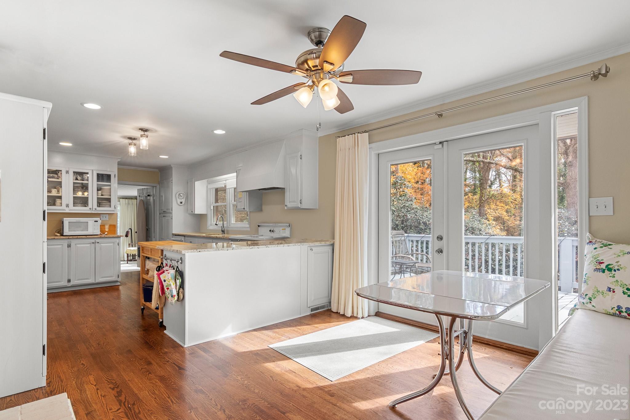 209 Country Club Road Shelby, NC 28150 - Photo 19 of 42 a living room with kitchen island furniture and a wooden floor