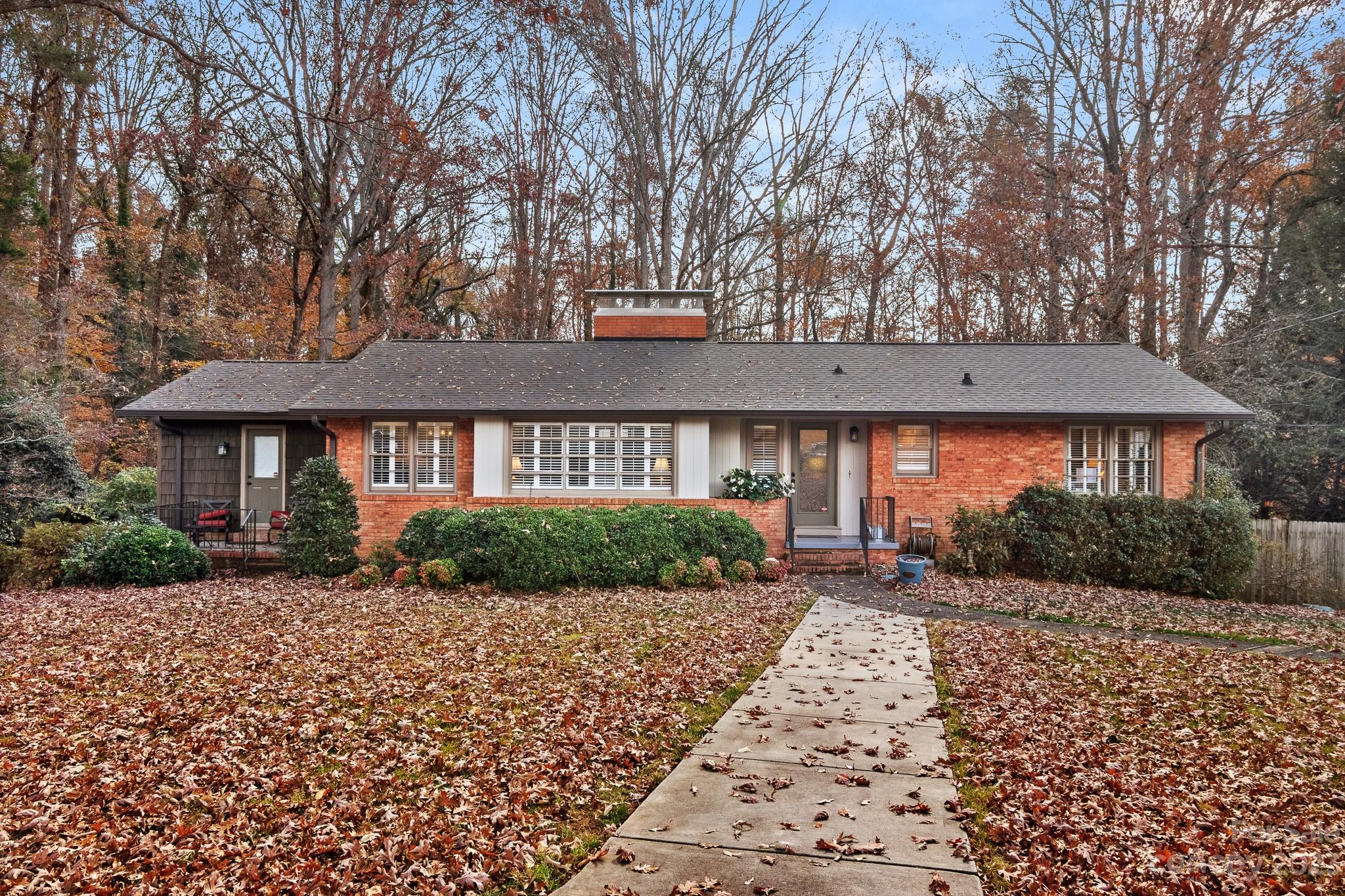 209 Country Club Road Shelby, NC 28150 - Photo 5 of 42 a front view of a house with a yard and potted plants
