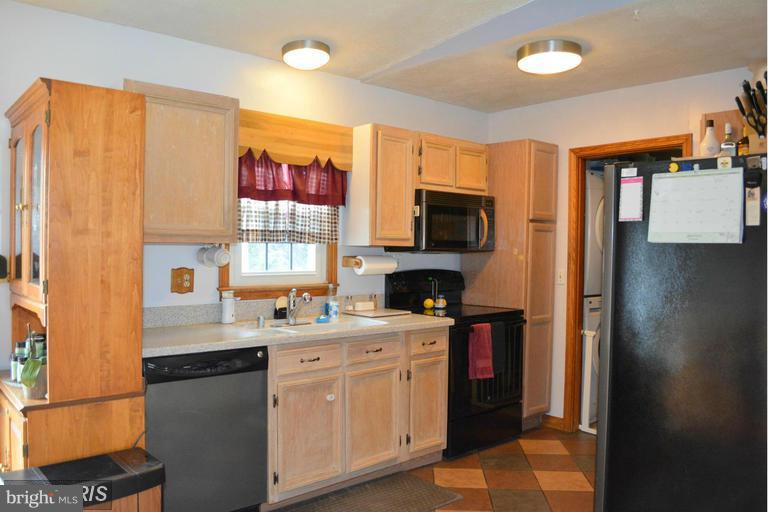 116 Rambo Court Linden, VA 22642 - Photo 14 of 30 a kitchen with a sink a stove and cabinets