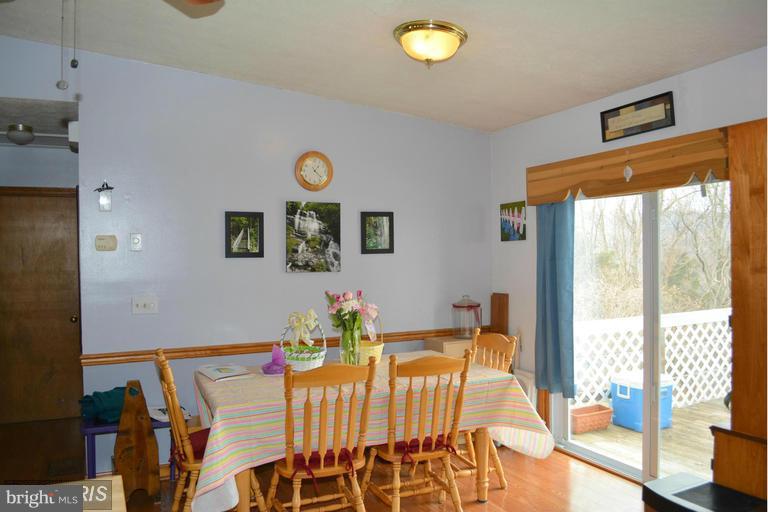 116 Rambo Court Linden, VA 22642 - Photo 17 of 30 a dining room with furniture and a potted plant