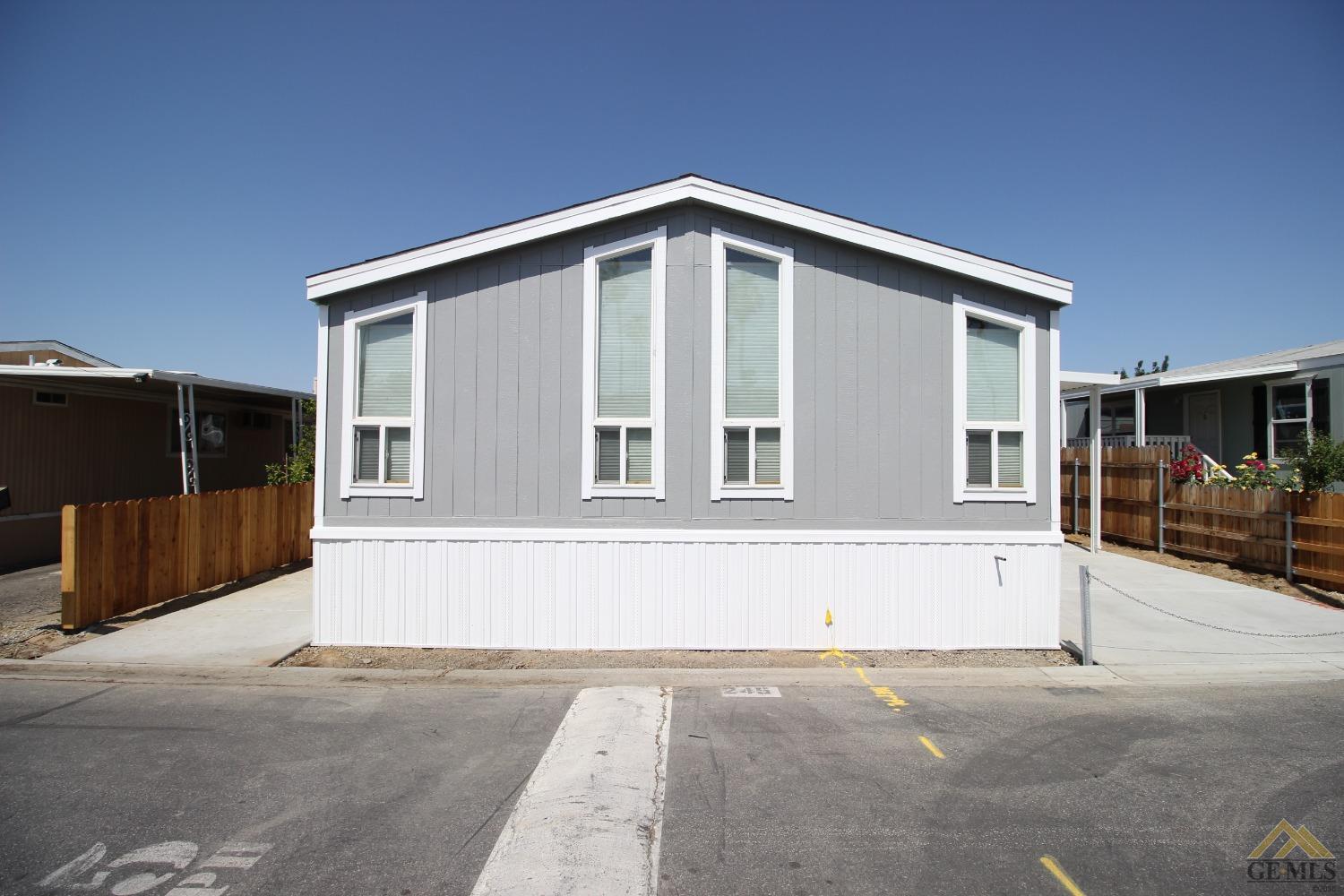 a view of an house with backyard and parking
