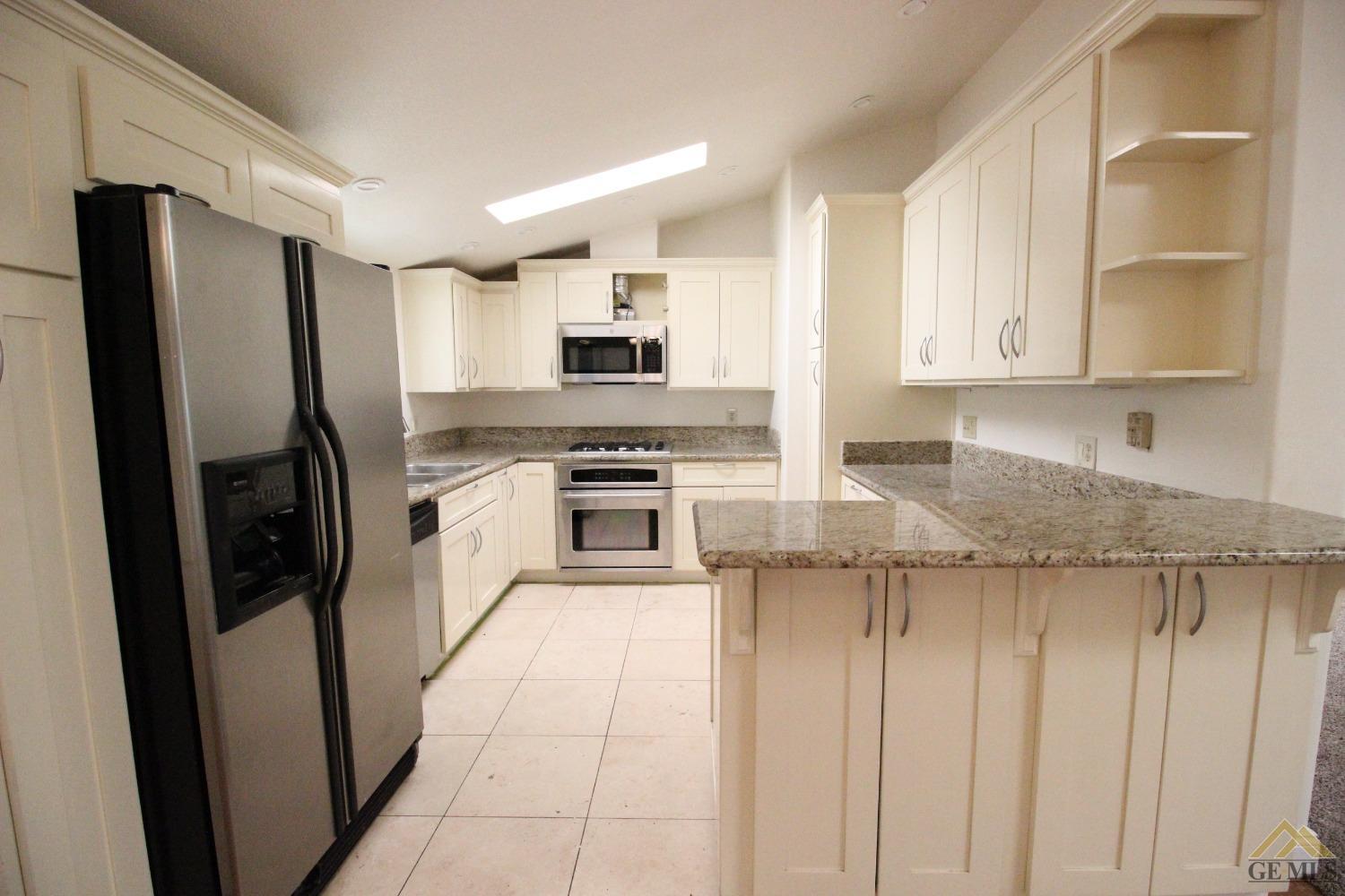 Undisclosed Address Bakersfield, CA 93308 - Photo 11 of 26 a kitchen with stainless steel appliances granite countertop a refrigerator a stove and a sink